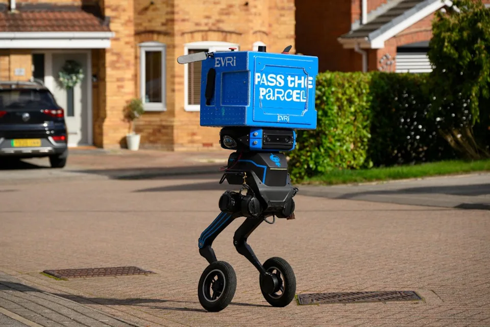 A blue delivery robot with two legs and wheels on a residential street in Barnsley