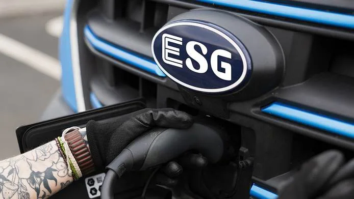 An electric vehicle is being plugged into a charger.