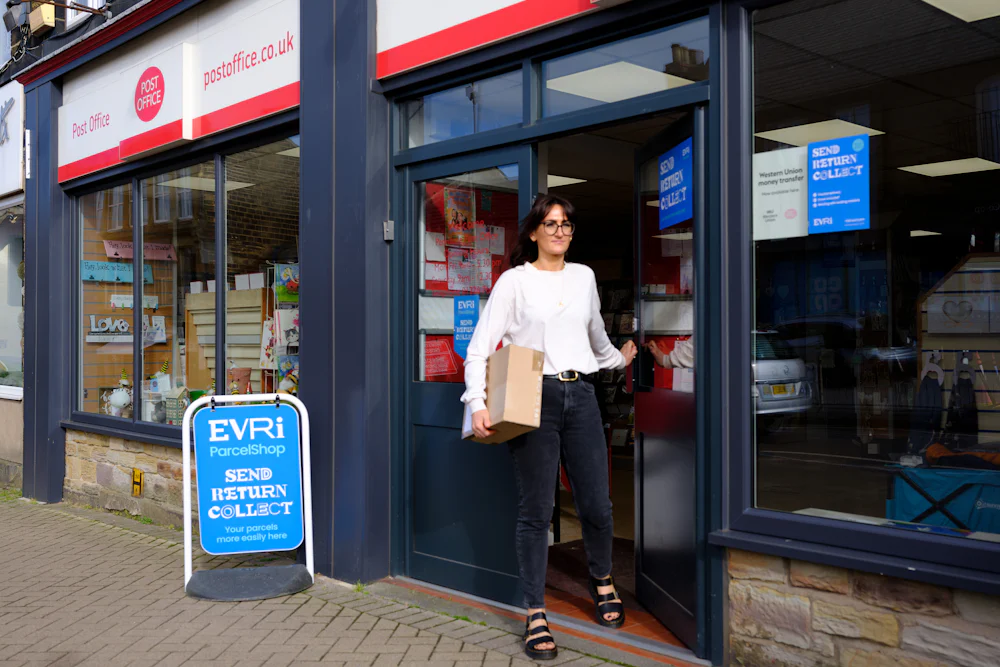 Woman collecting parcel from Post Office