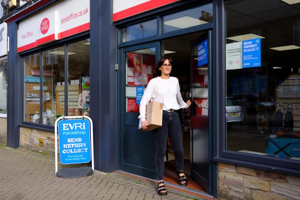 Woman collecting parcel from Post Office