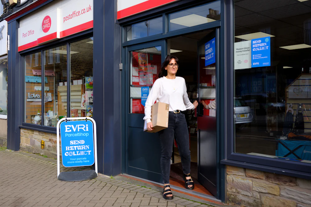 Woman collecting parcel from Post Office