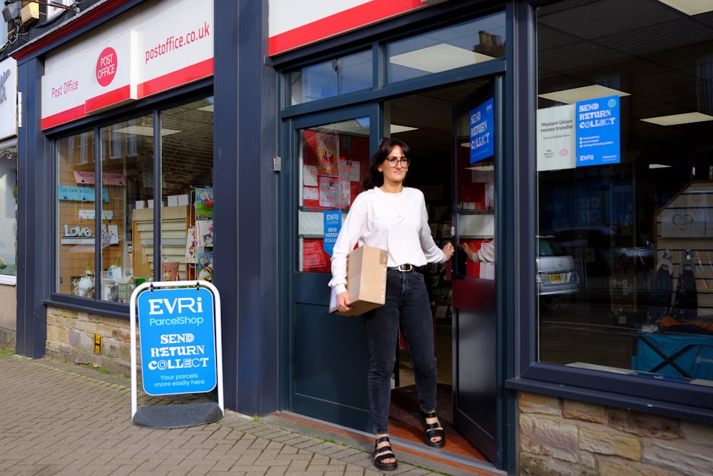 Woman collecting parcel from Post Office