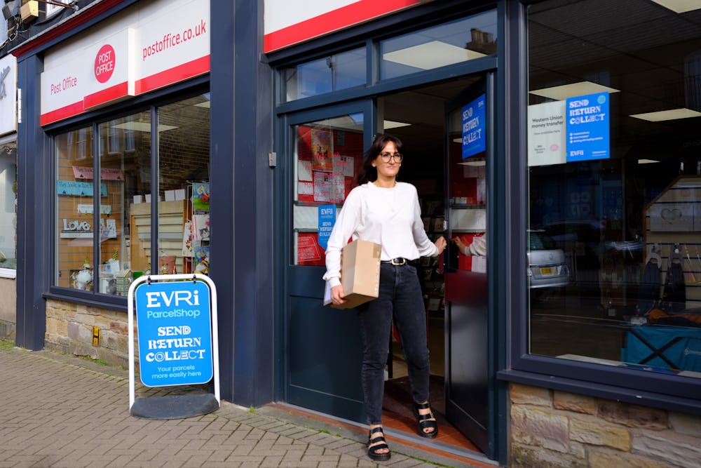 Woman collecting parcel from Post Office