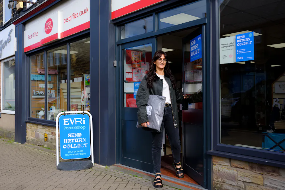 Woman collecting parcel from Post Office