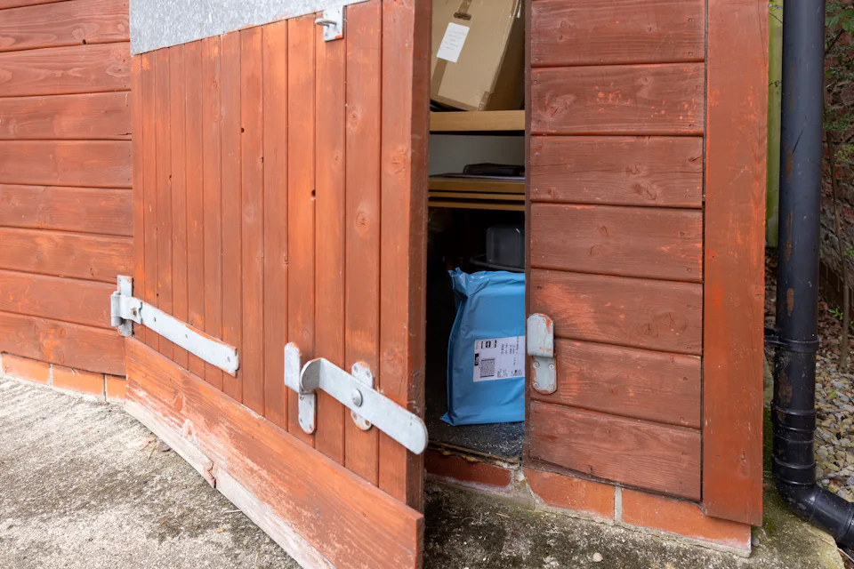 A parcel has been placed inside a garden shed out of public view and protected from the elements.