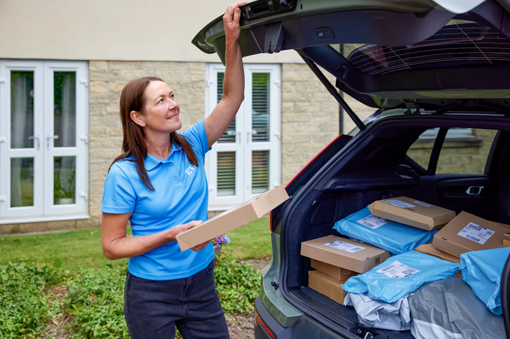 An Evri Courier closing their boot after retrieving the correct parcel for a delivery