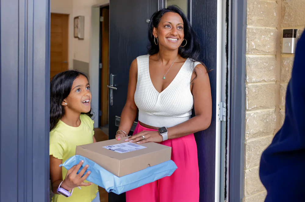 A mother and child thanking their Evri Courier after a satisfactory delivery of two parcels