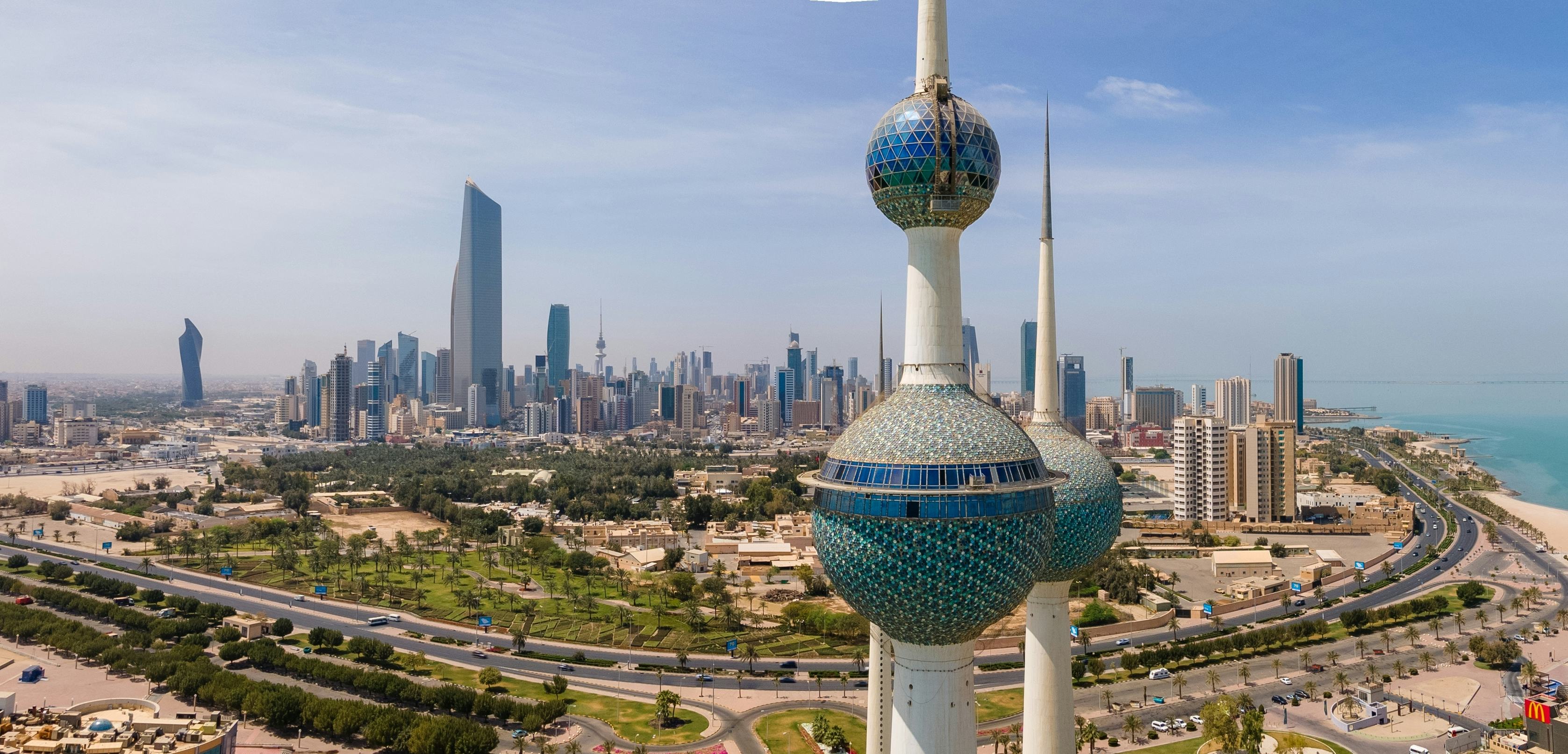 A skyline view of Kuwait City can be seen with the famous Liberation Tower in the foreground.