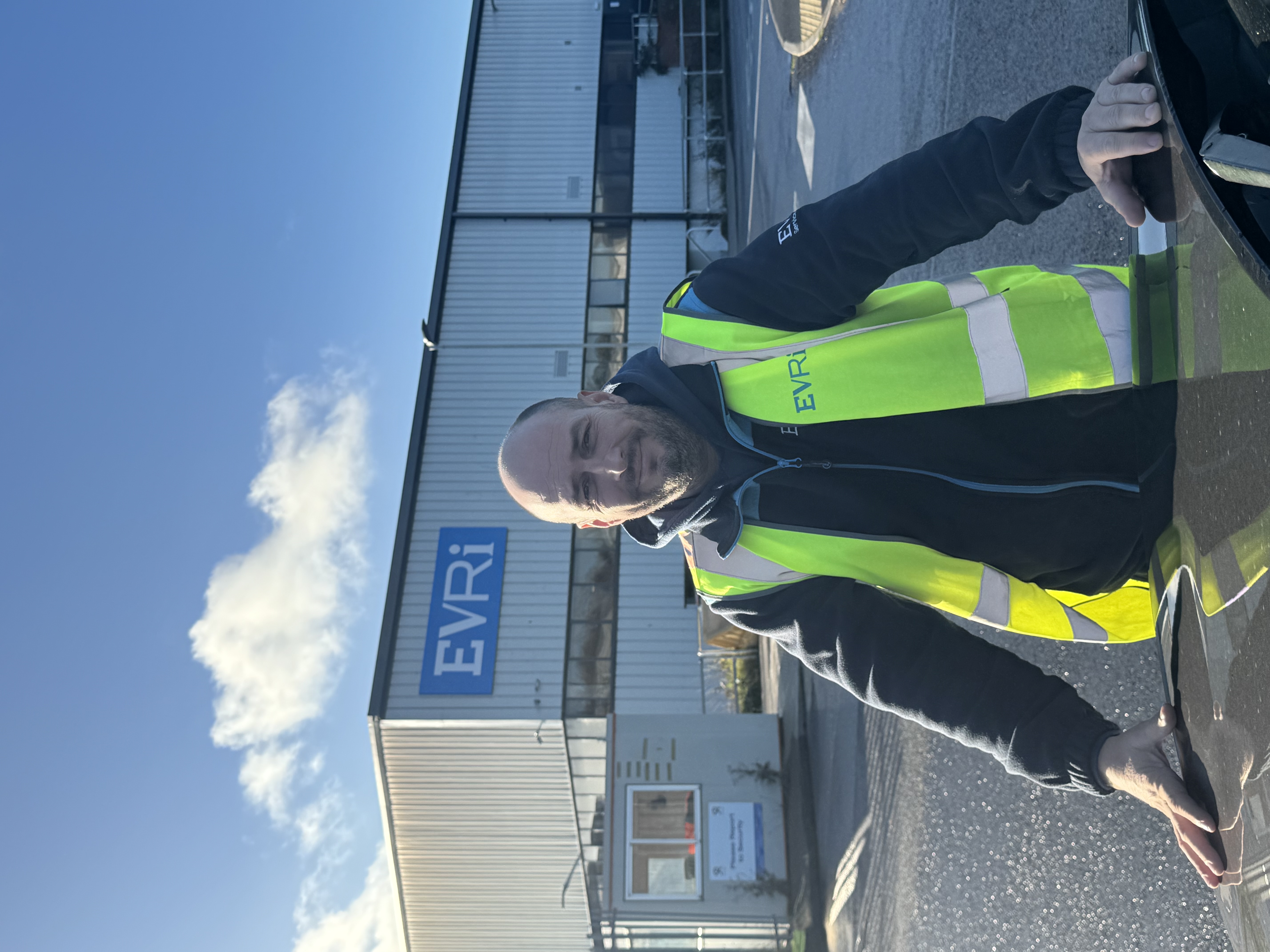 A photo of Evri courier, Michael McMullen, in uniform at an Evri depot