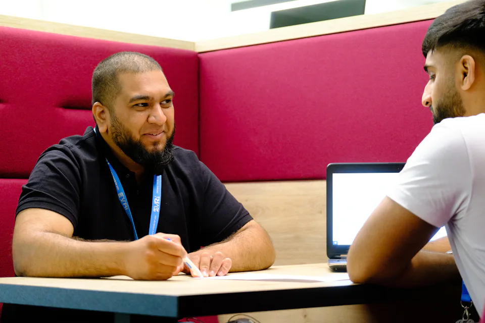 Two Evri colleagues work together at a table
