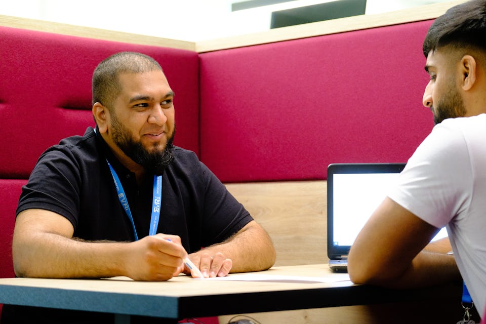Two Evri colleagues work together at a table