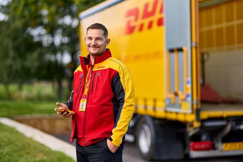 dhl male stood outside dhl lorry