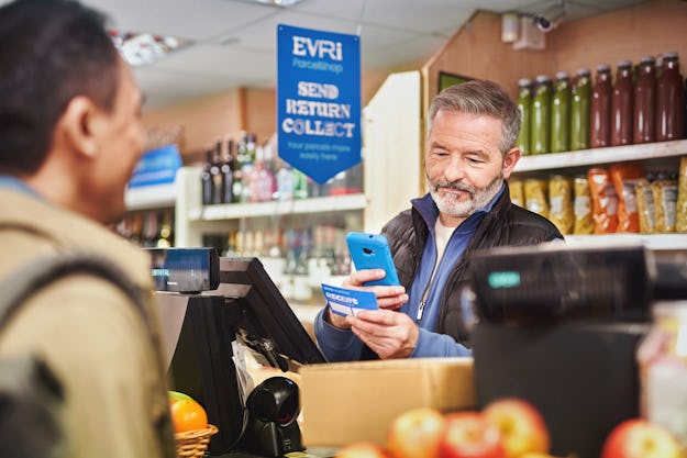 cashier scanning customers parcel on shop counter