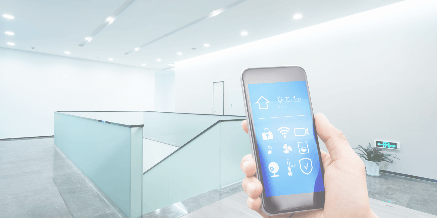 Hand holding a smartphone with an integrated security app in a clean modern building
