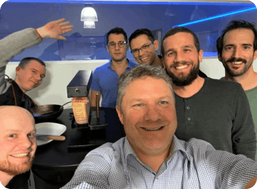 Photo of a happy evalink team taking a selfie at an after-work team building event 