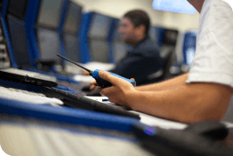 Close up of an operator holding a walkie talkie in a control center