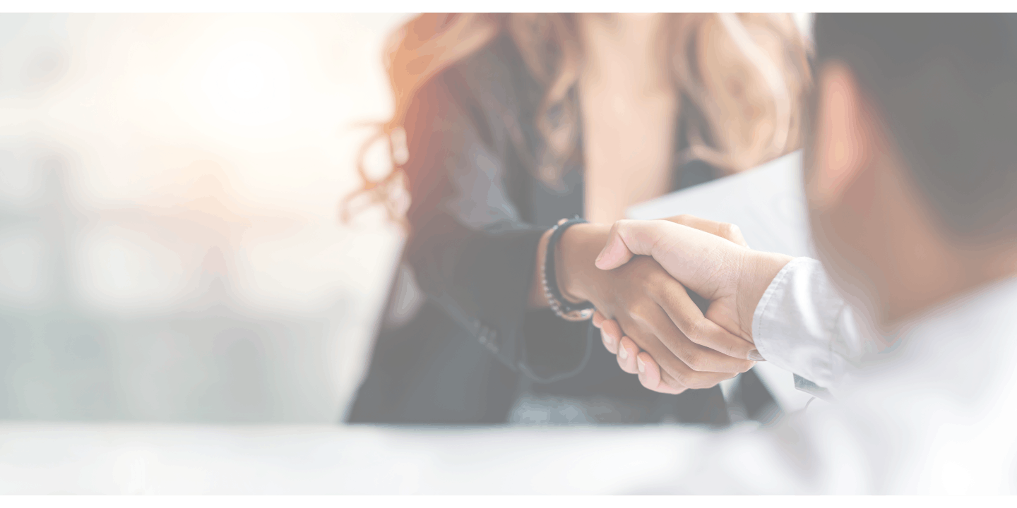 Business woman with blond long hair shaking hands with a client 