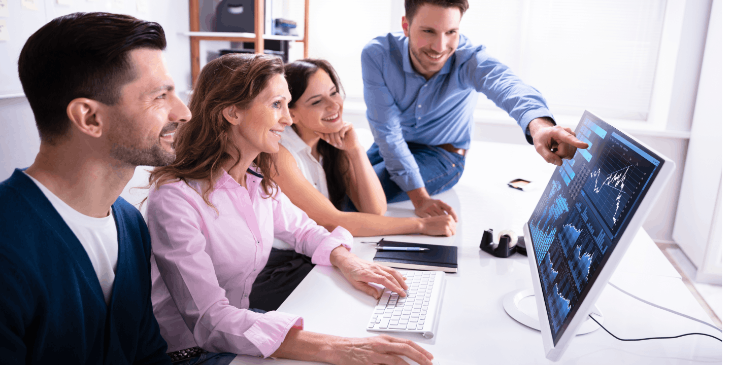 Young business team in good mood looking at a computer screen together