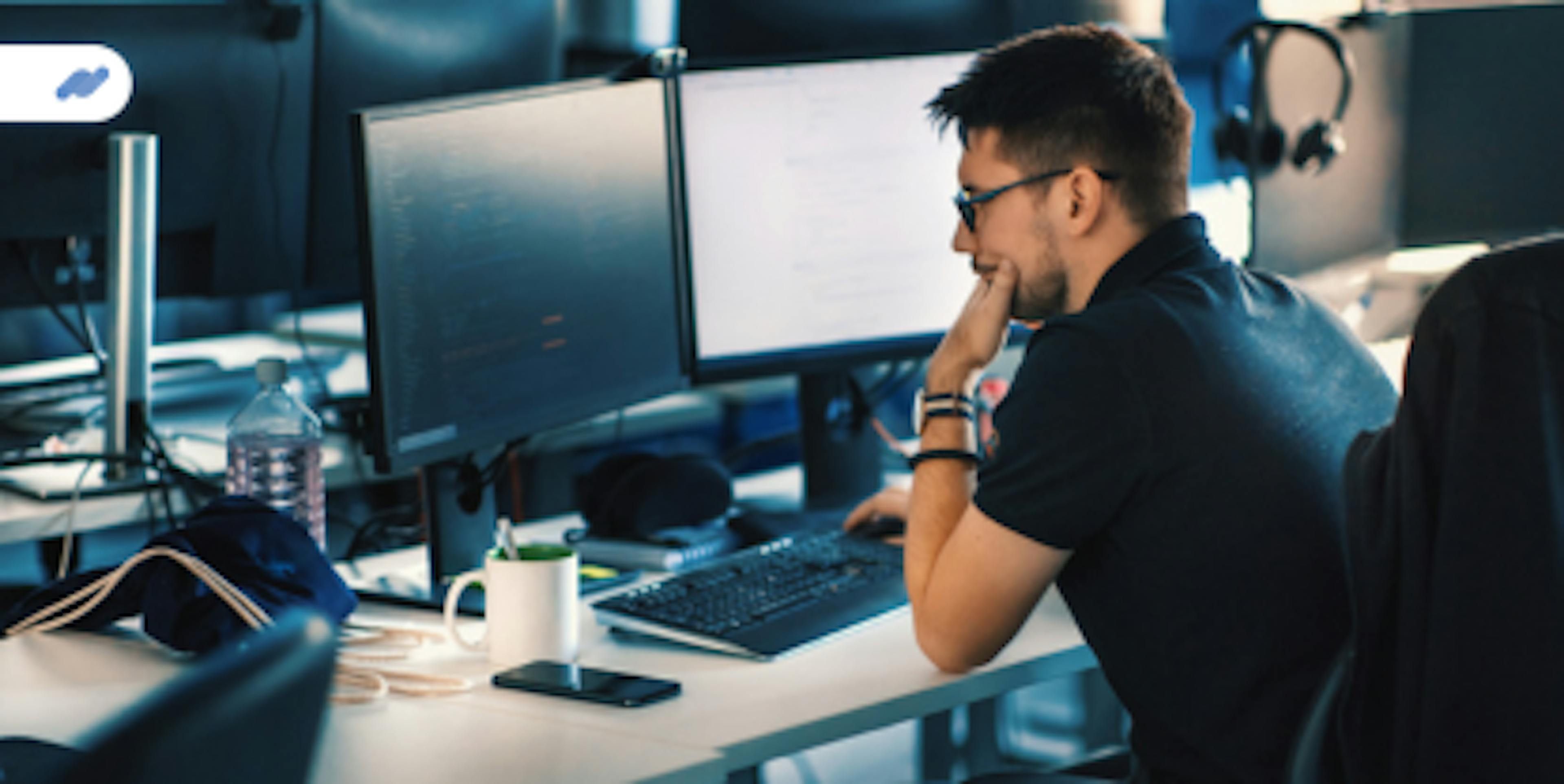 man working in front of computer evalink dev