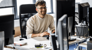 man looking at screen talking in office