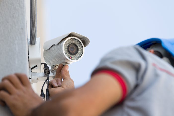 A man installing a security surveillance camera