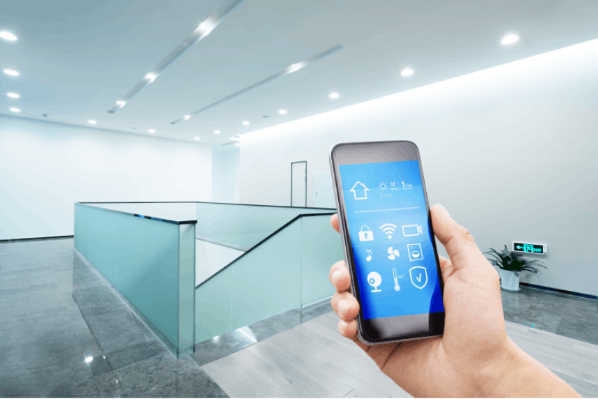 Close up of a hand holding a phone with smart security in a clean modern building