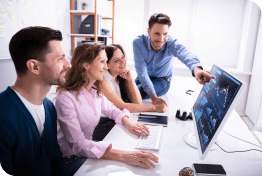 Young business team in good mood looking at a computer screen together