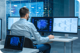 Control room operator working at multiple screens