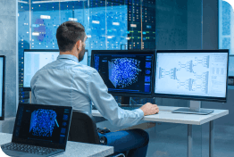 Control room operator working at multiple screens 