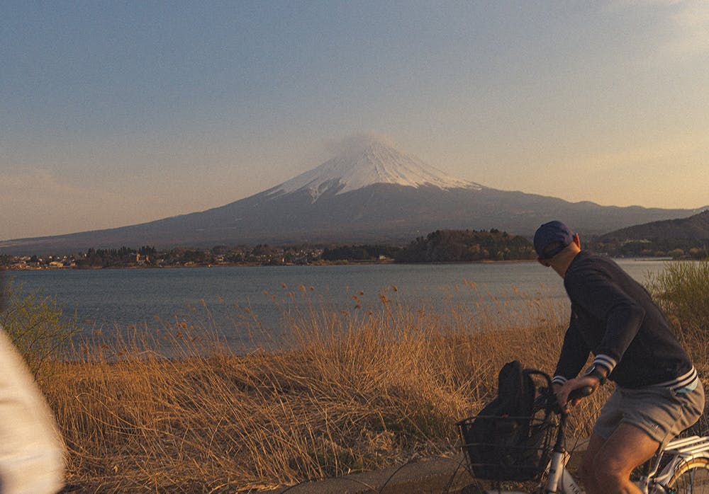 cycling man with lake and mountain