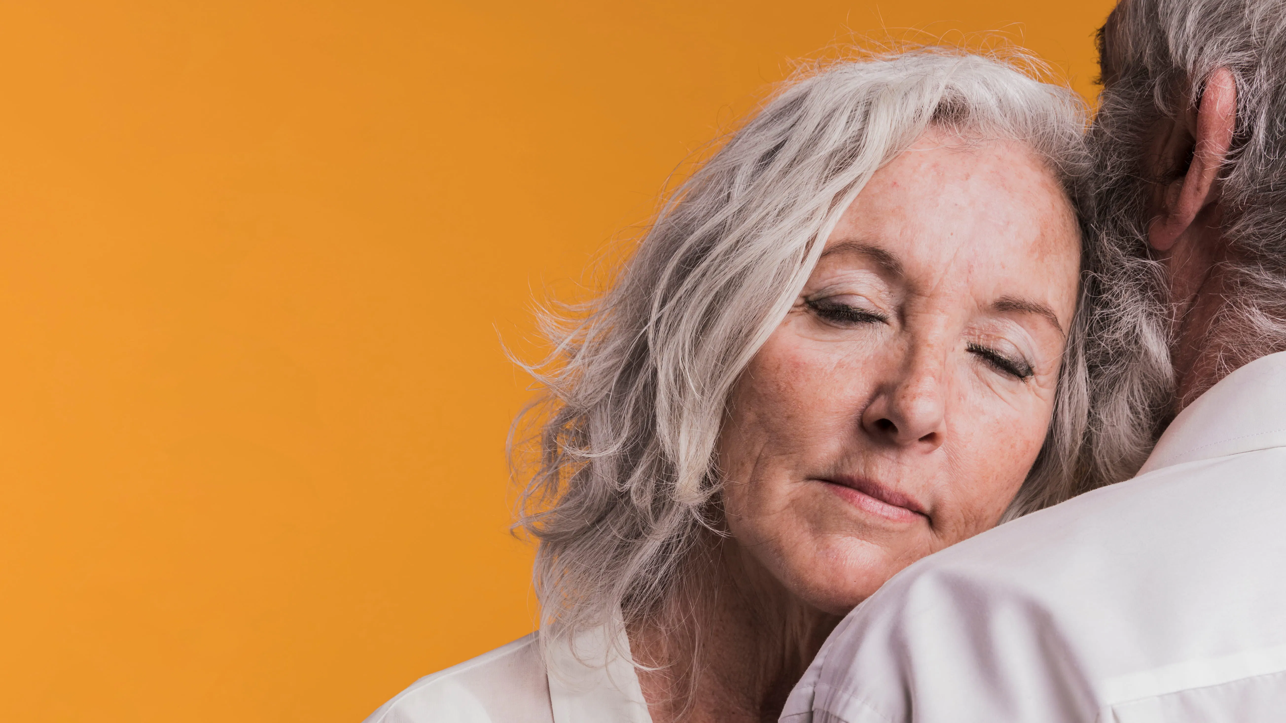 Mature woman leaning on her partner, representing intimacy and emotional connection during menopause