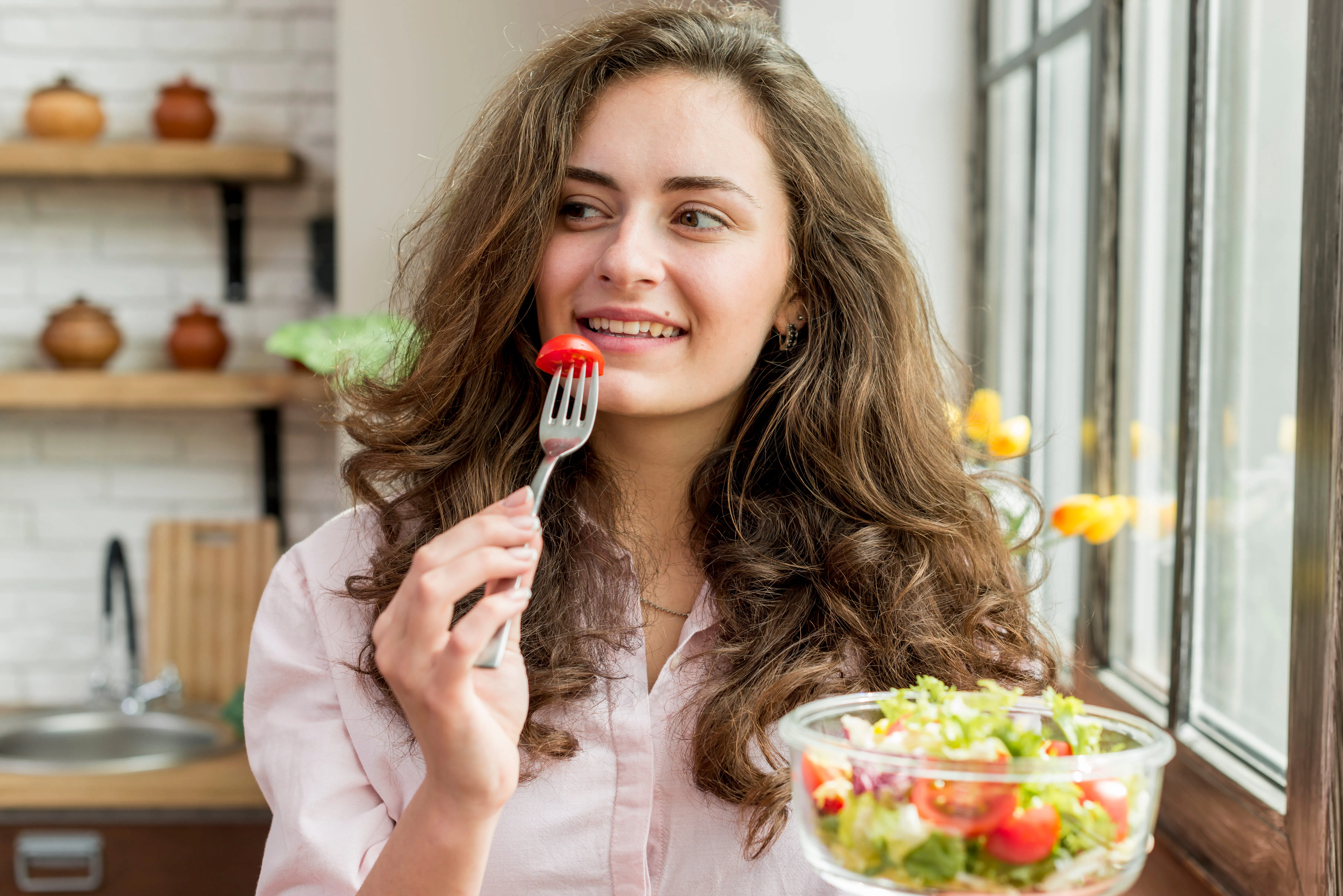 Woman enjoying a fresh, nutrient-dense salad to support metabolic health and hormonal balance during menopause