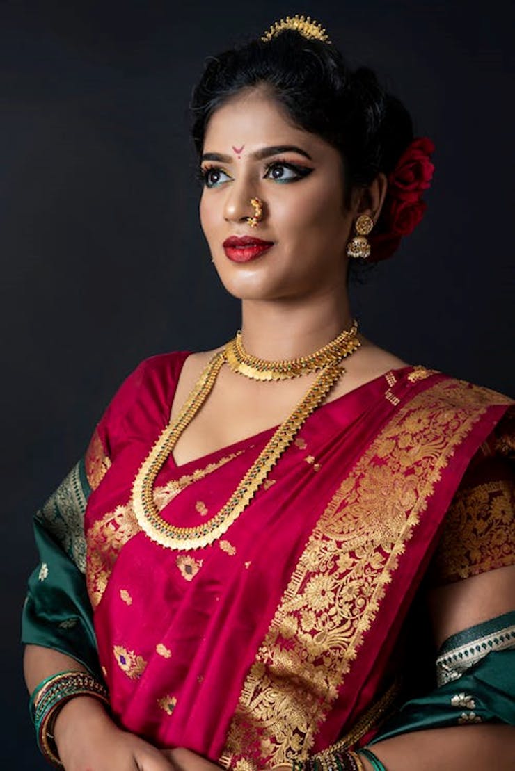 2. Red heavy Silk Saree with intricate Motifs in Bengali Wedding Dress: