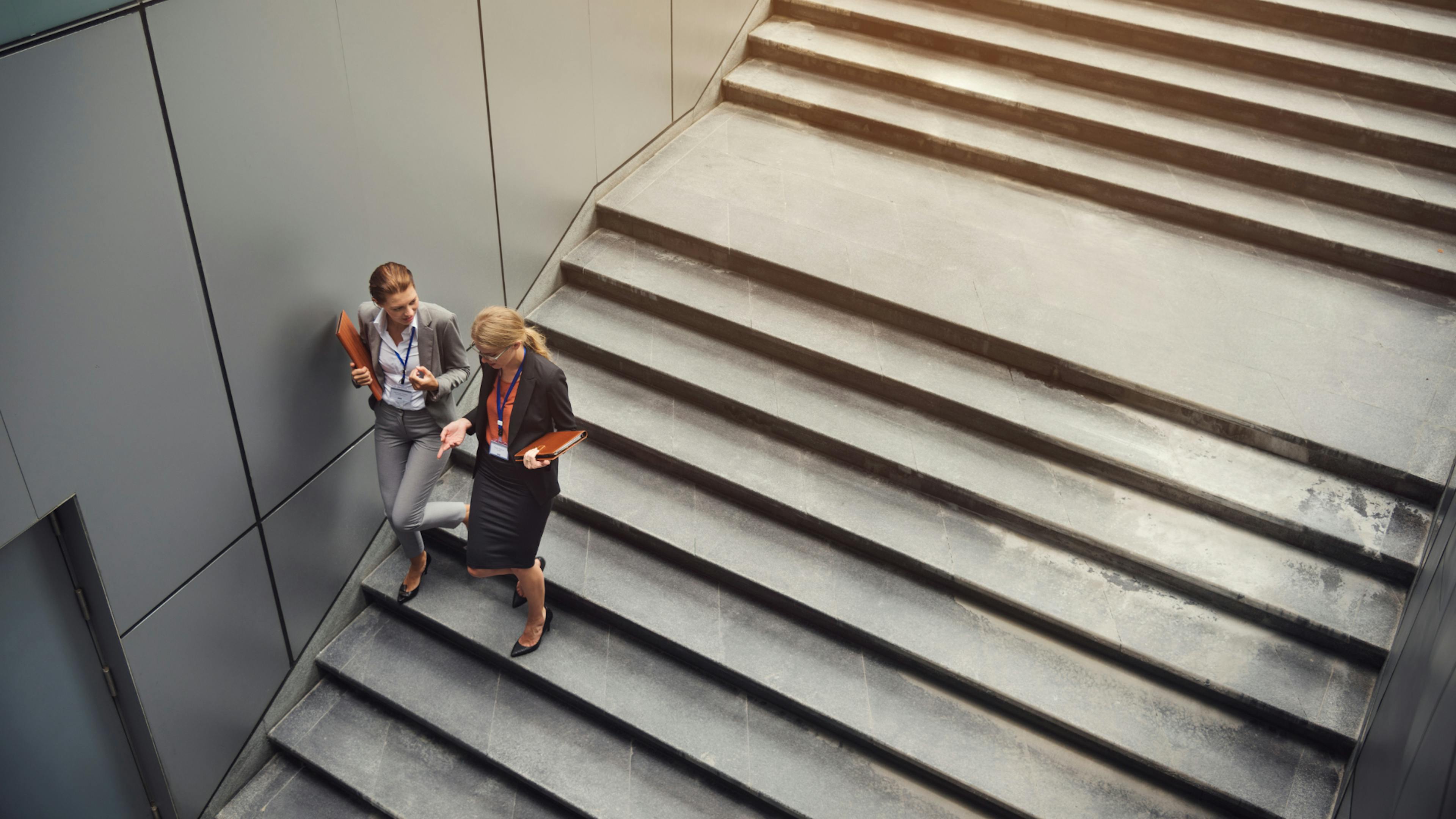 Working girls talking on the stairs