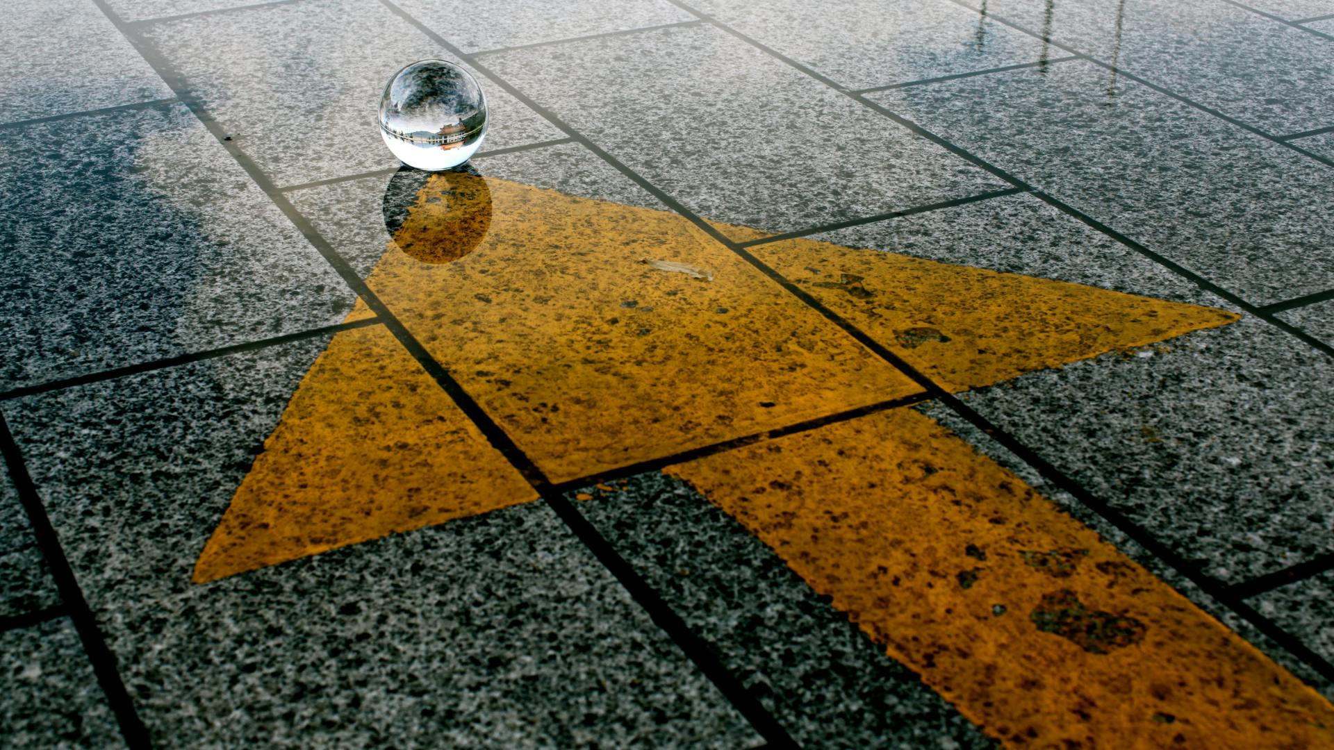 transparent ball on the ground with a yellow arrow pointing towards it