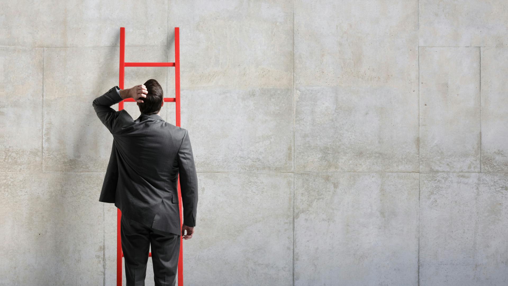 Man wondering how to climb a wall