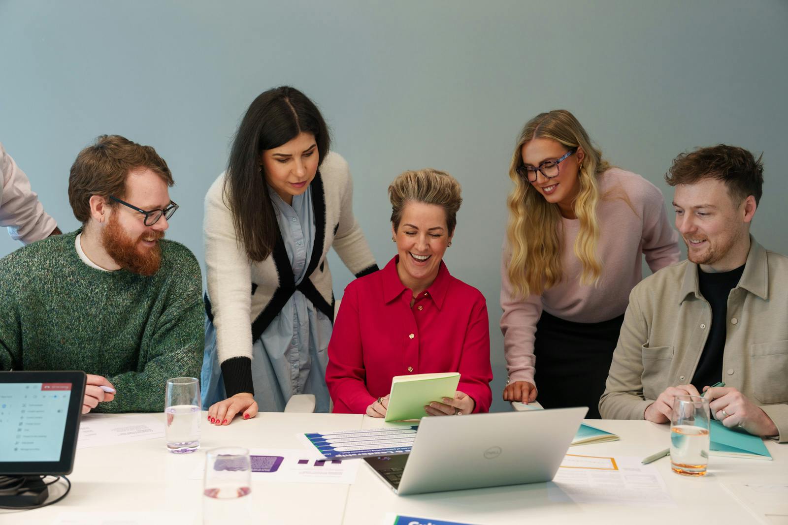 A group of Everway team members gathered around a desk