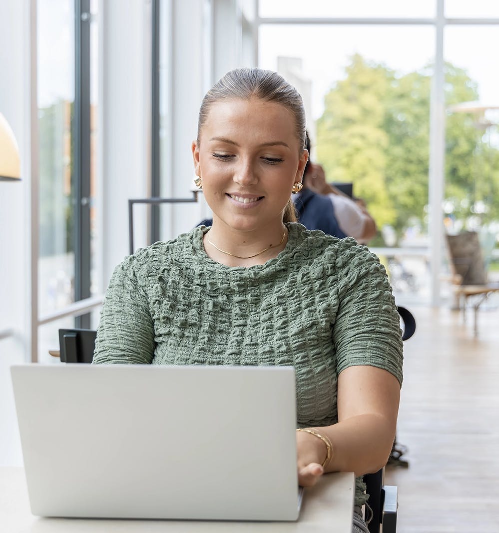 A student using a laptop in a library