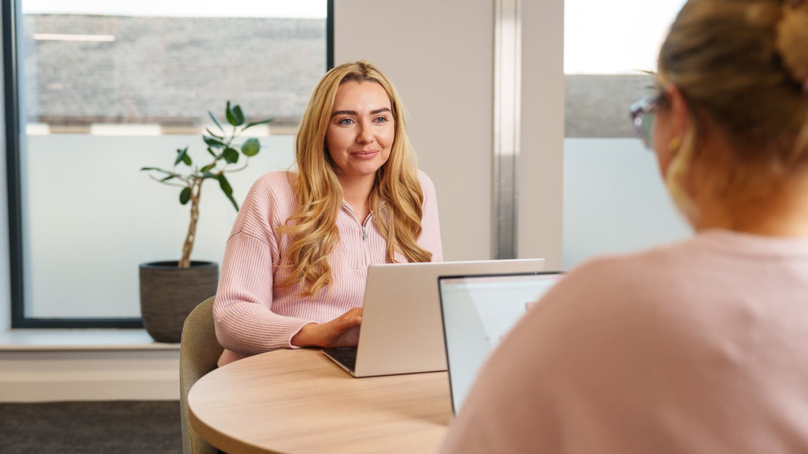 An employee at a laptop at a desk