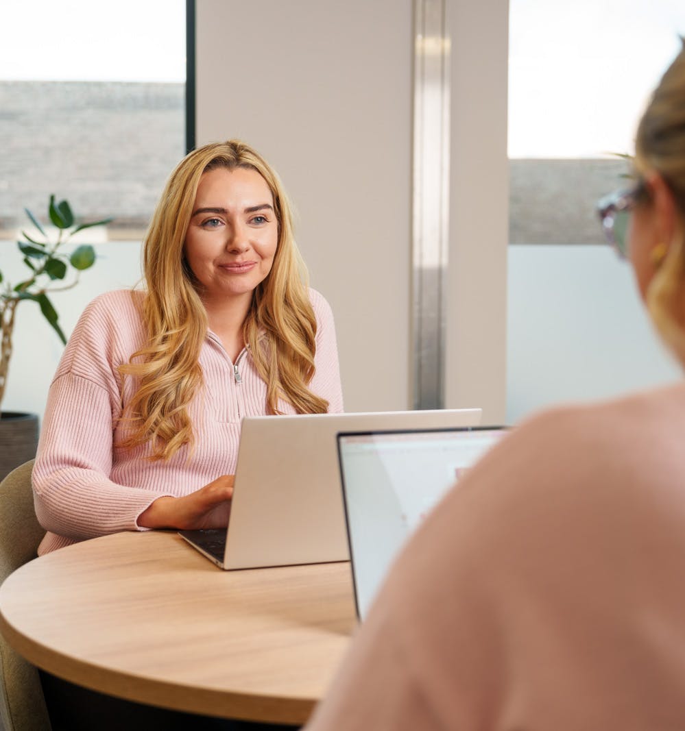 An employee at a laptop at a desk