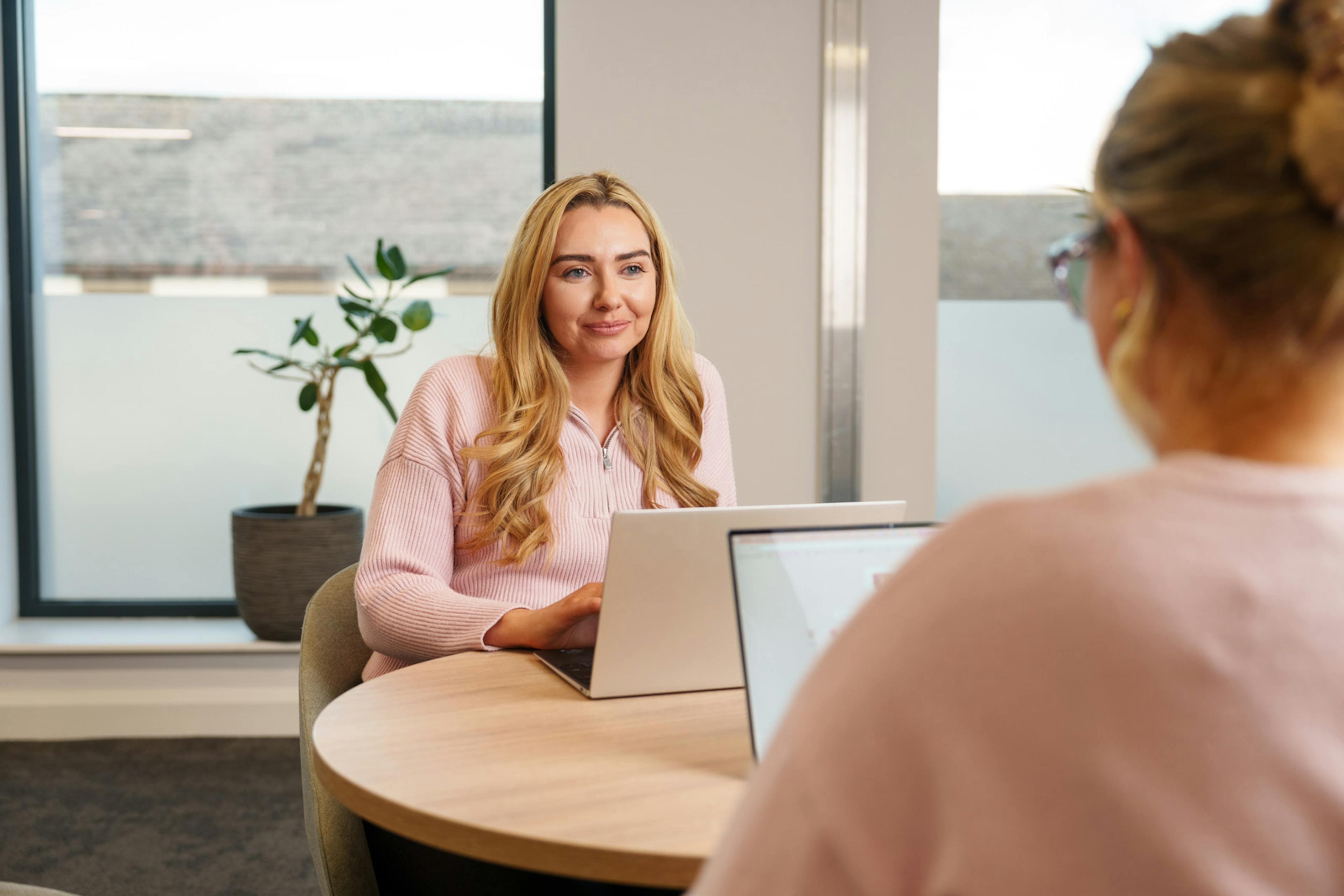 An employee at a laptop at a desk