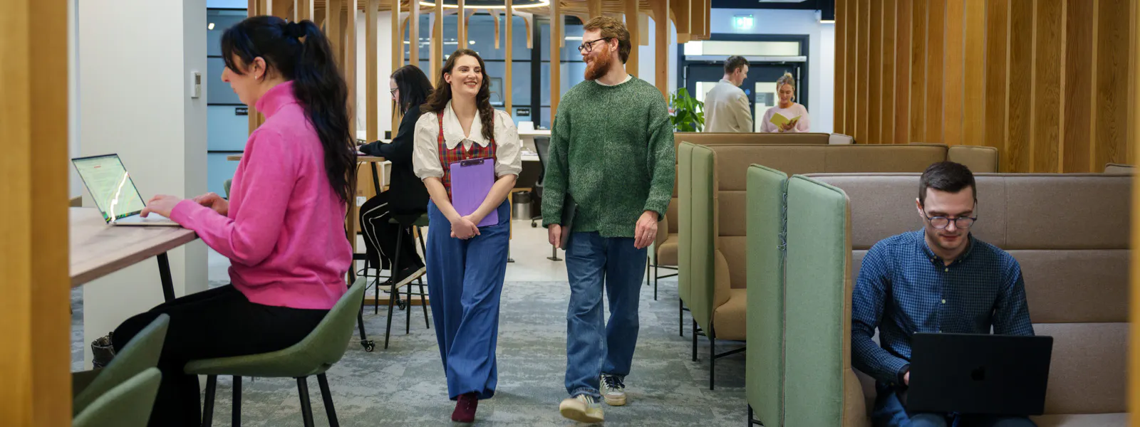 Employees walking in a busy office