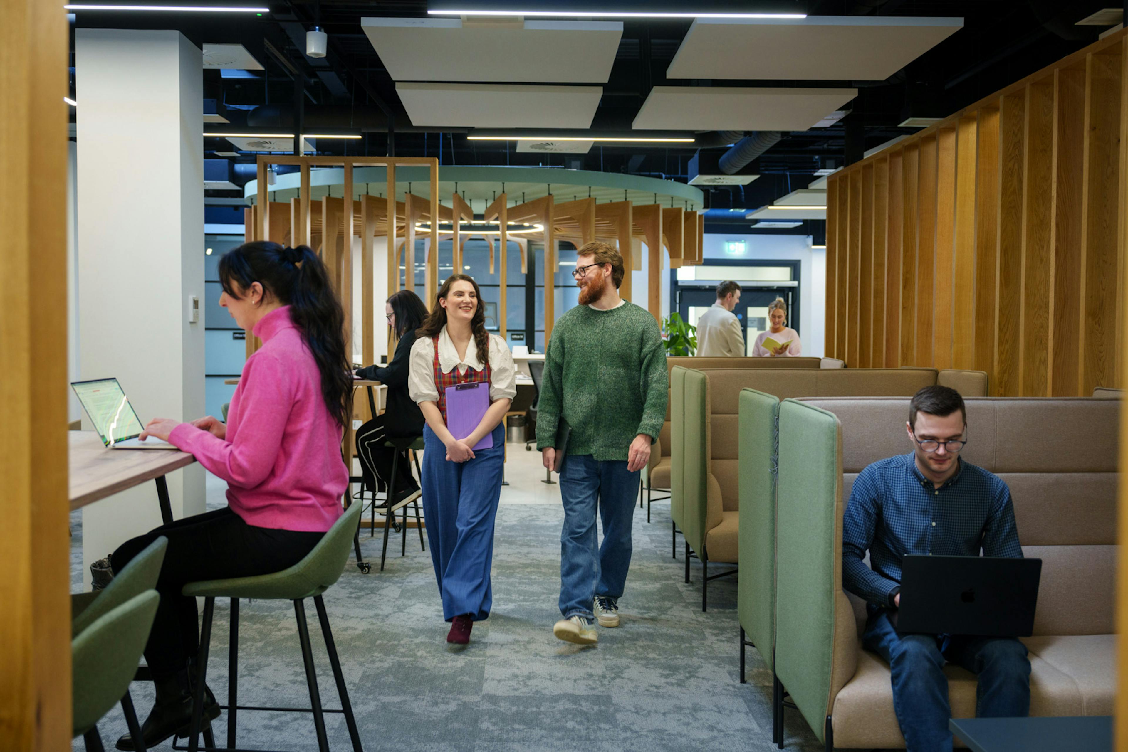 Employees walking in a busy office