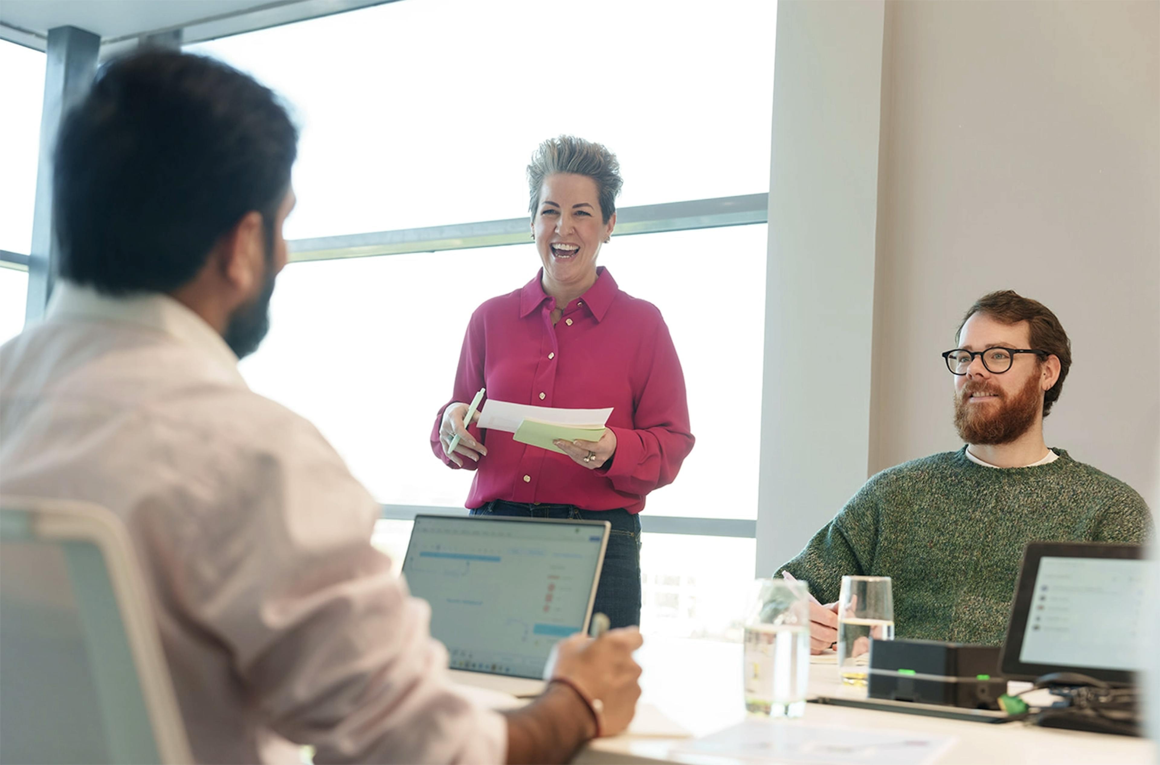 A team leader speaking to two employees in a meeting