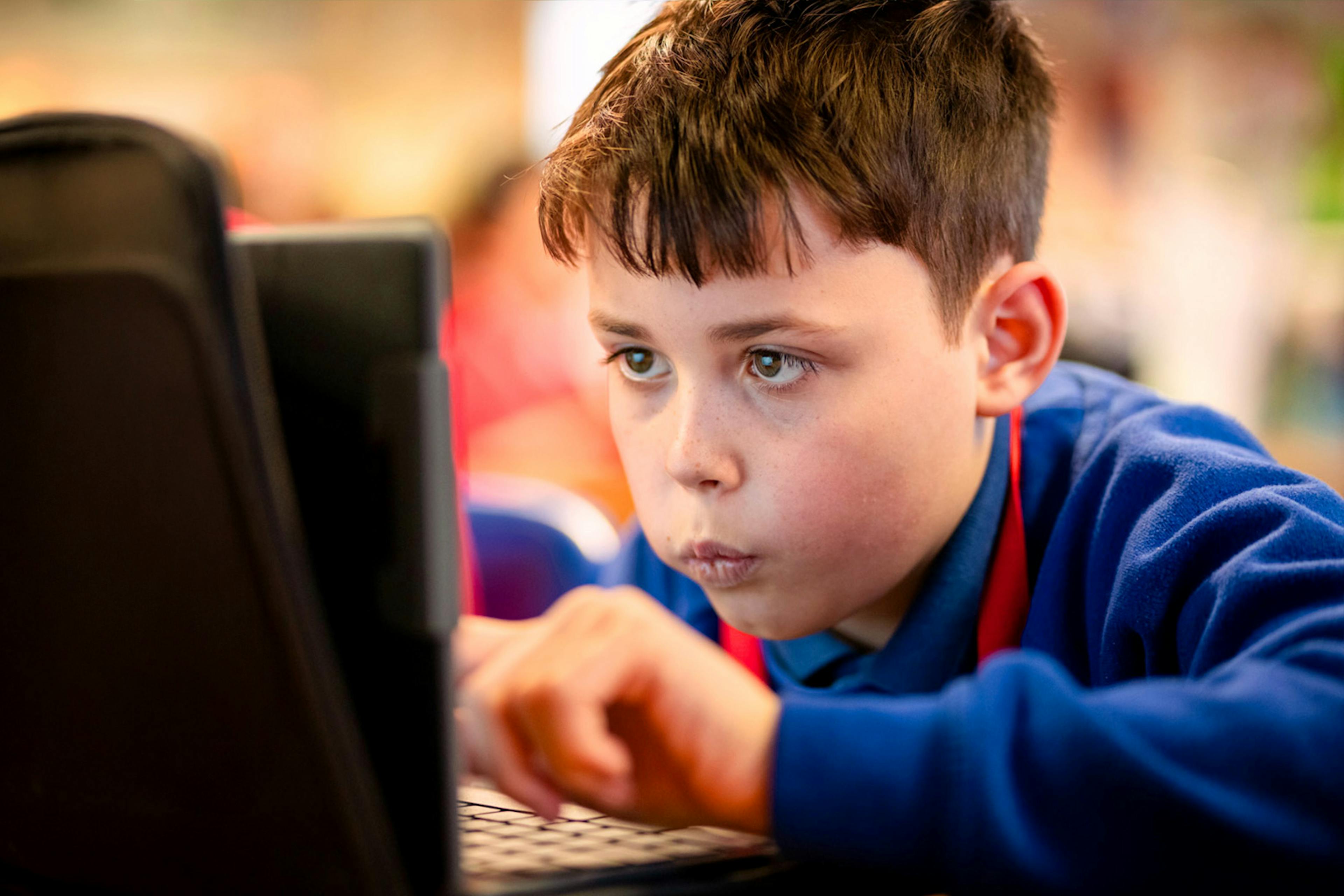 A student concentrating on a laptop