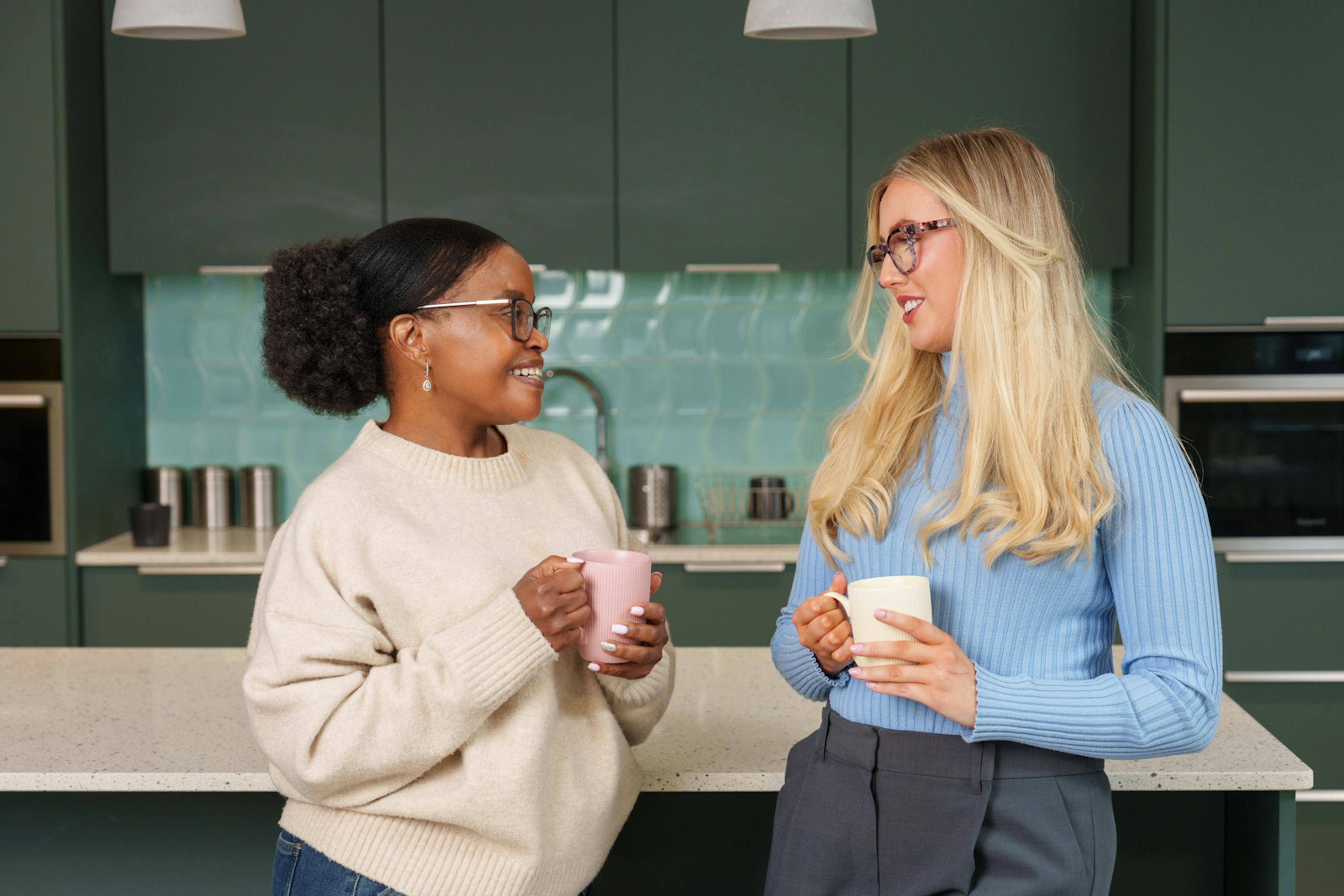 Two team members chatting in a kitchen environment