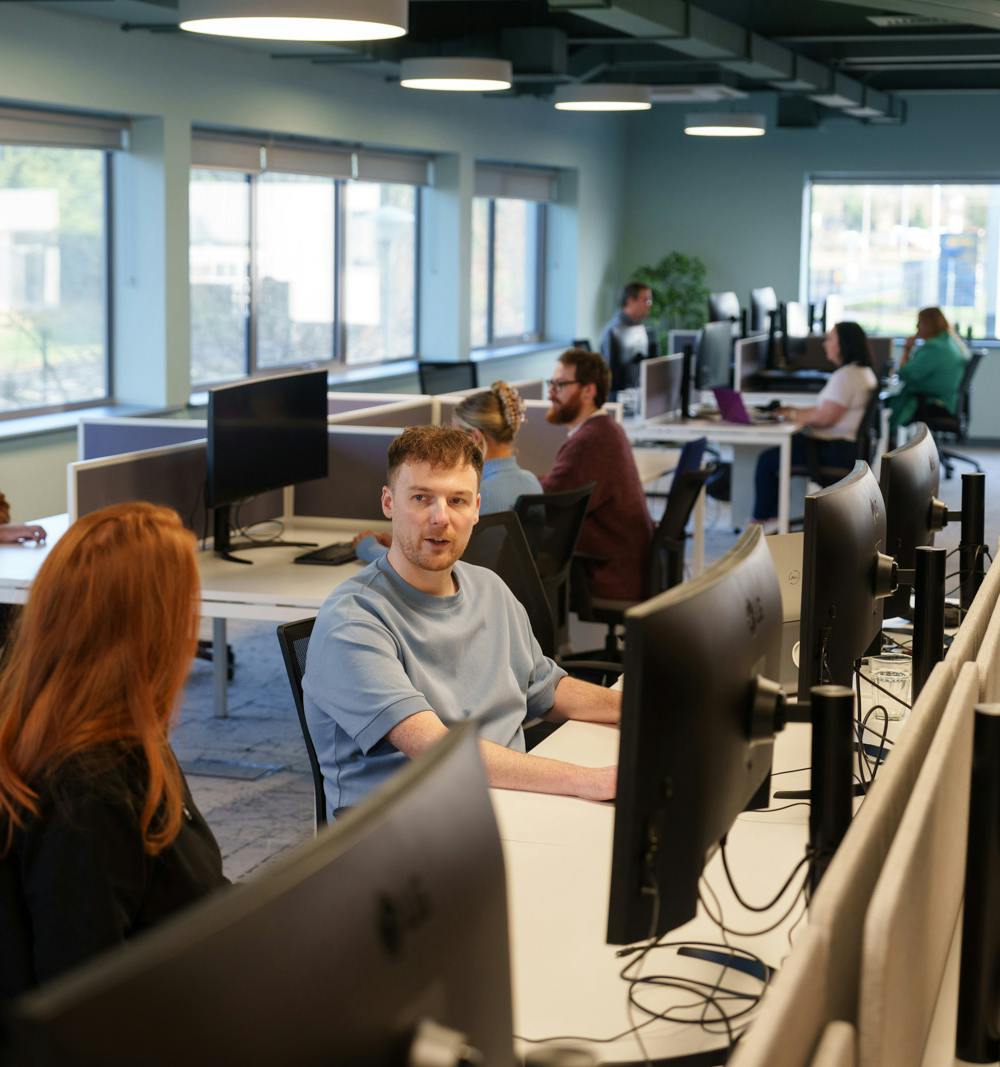 Two team members chatting in an open office space