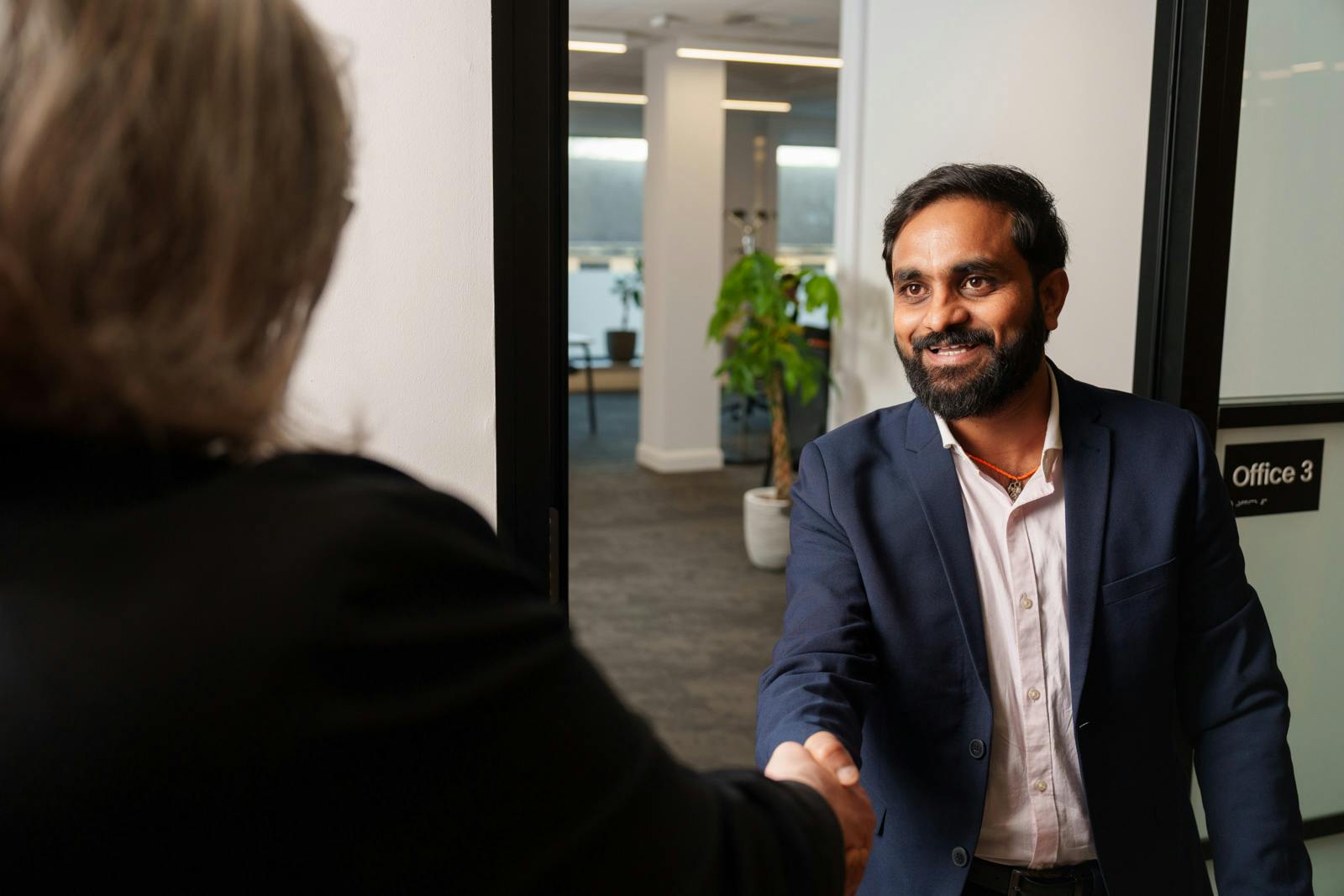 A job candidate shaking hands with an Everway team member