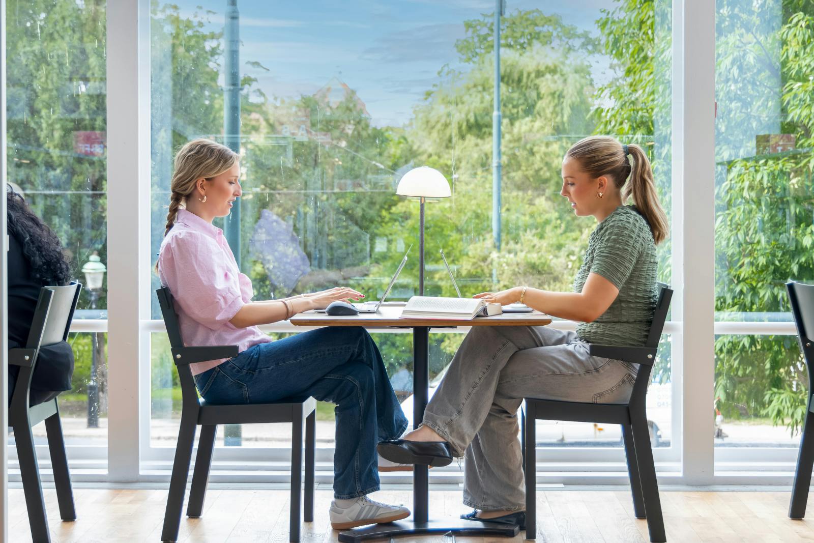 two girls facing each other at a desk
