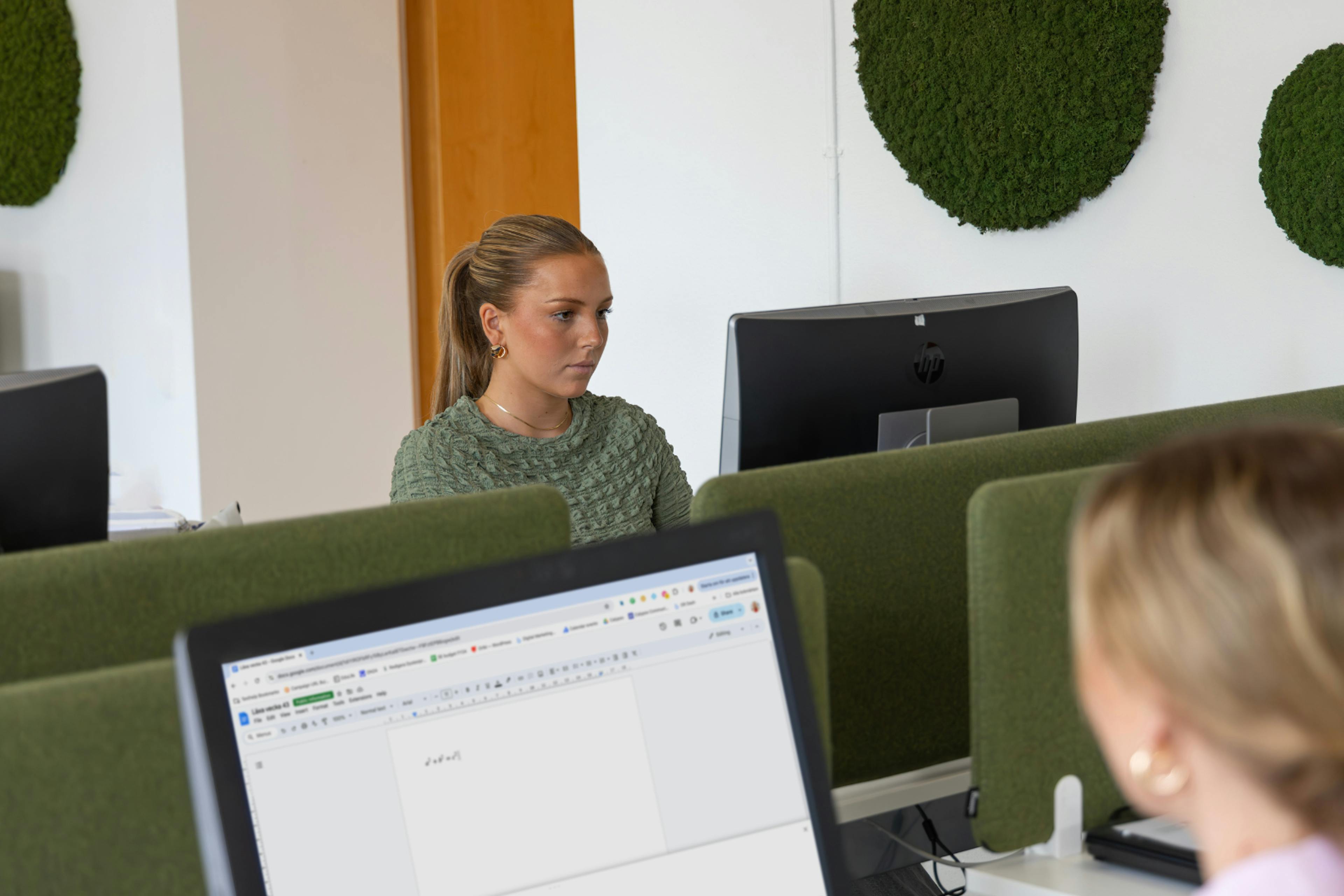 a computer lab with two girls in it